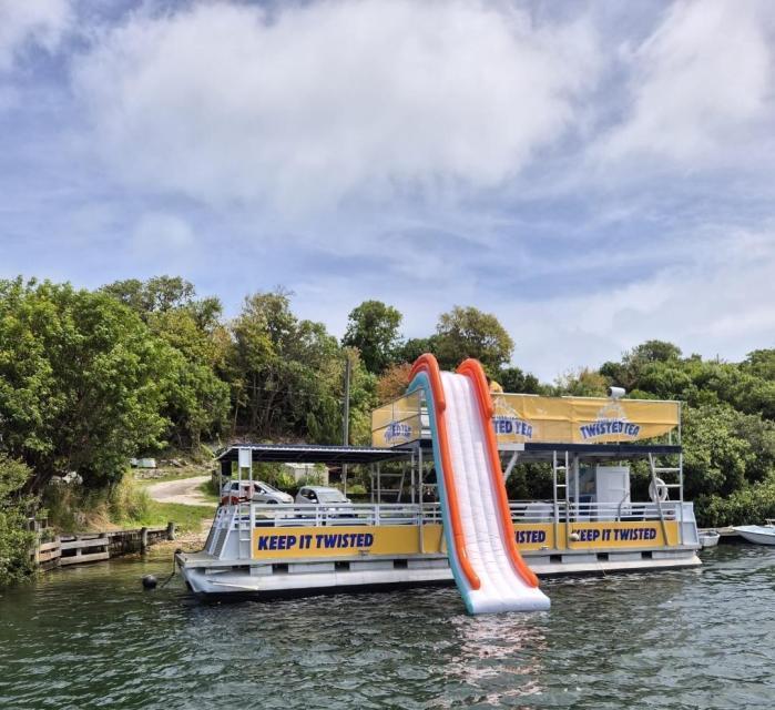 The Pontune Paradise pontoon boat dockside with the water slide deployed